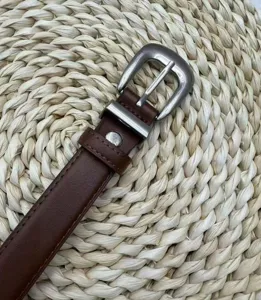 Women's brown leather belt with stylish silver metal pin buckle for casual jeans wear.