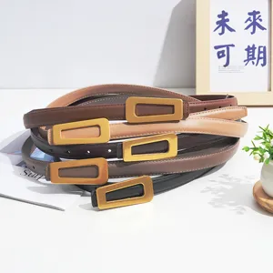 Detailed view of stacked women's genuine leather belts featuring unique geometric metal buckles.