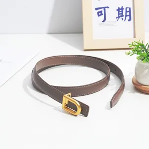 Women's brown leather belt featuring a sleek gold tone D buckle and delicate edge stitching.