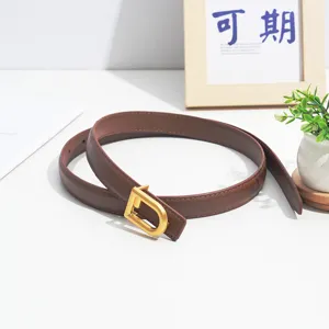 Detailed view of women's brown leather belt with stylish gold D buckle, chic daily accessory.