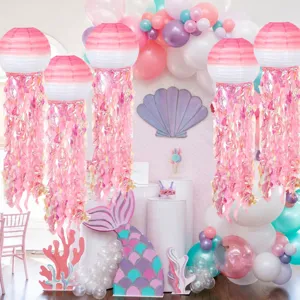 Pink gradient jellyfish paper lantern detail showing shimmering fringe and hanging party decor.