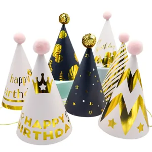 Children birthday party cone hats with gold foil patterns and cute pom-poms for celebrations.