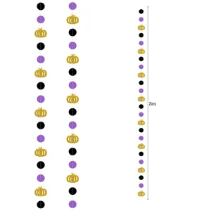 Halloween paper garland with black purple dots and gold glitter pumpkins for party decor.