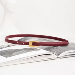 Minimalist women's thin leather belt with gold buckle, elegant dress and jeans waist accessory.