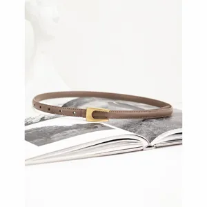 Minimalist thin leather belt for women, genuine cowhide strap with elegant metal buckle.