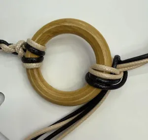 Bohemian braided waist belt detail showing wood ring and woven ropes for dress styling.