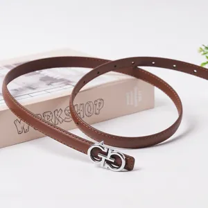 Women brown thin leather belt with silver tone metal buckle, elegant waist accessory for jeans.