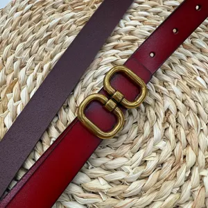 Red leather women waist belt with vintage gold tone double buckle, chic trousers strap.