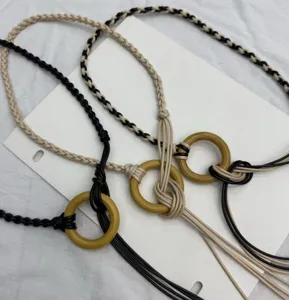 Bohemian handmade woven waist chain with wooden ring and elegant tassel details.