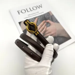 Minimalist genuine leather belt for women featuring elegant gold knot buckle, slim suit waist.