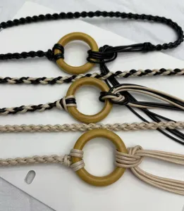 Detailed close-up view of bohemian braided waist chains featuring wooden rings and tassel accents.