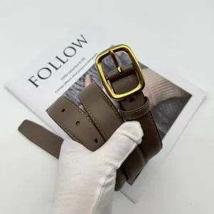 Detail view of a stylish brown leather belt with a gold square buckle and neat stitching.