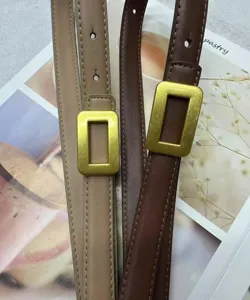 Close up of minimalist women leather thin belt with metallic rectangular buckle detail style.