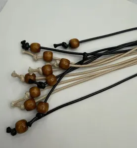 Close-up detail of handmade woven waist rope with wooden beads, showing exquisite craft.