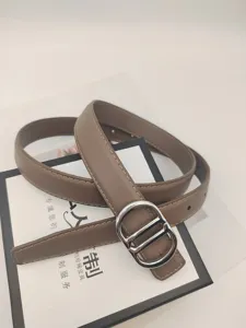 Women brown leather belt with silver metal buckle, stylish design for jeans dresses and suits.