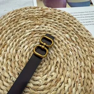 Detailed view of the vintage leather belt featuring a stylish gold double buckle design.