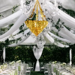 Detailed view of shiny gold and silver hanging chandelier party decorations for weddings.