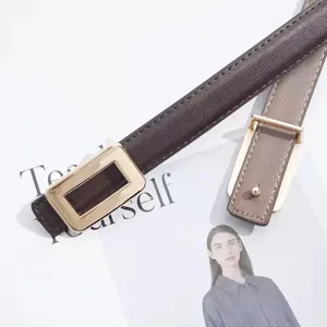 Detailed shot of thin leather belt with gold buckle, elegant accessory styling detail.