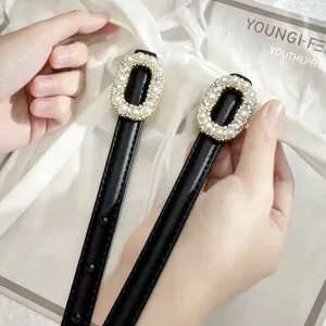 Genuine leather women belt with elegant pearl rhinestone buckle, chic black thin waist accessory.
