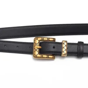 Detail view of women black leather belt with ornate antique gold buckle and geometric loop.