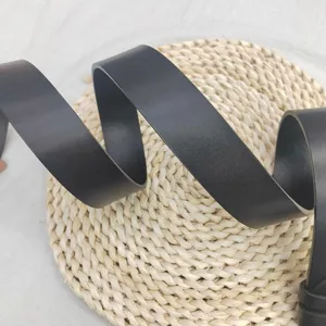Detail view of men's black leather belt showcasing smooth texture and elegant coiled design.