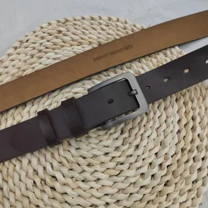 Detailed view of men's brown genuine leather belt with vintage metal pin buckle casual style.