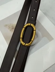 Brown leather belt for women with unique gold oval buckle, stylish jeans accessory detail.