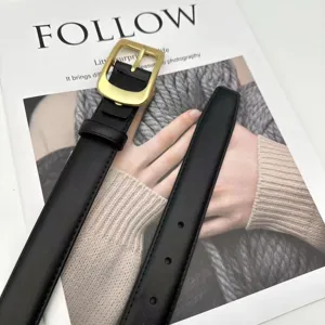 Detailed shot of a black genuine leather women belt with a gold-tone buckle, stylish accessory.