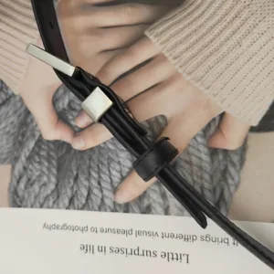 Minimalist black leather belt for women with sleek metal buckle for daily elegant outfits.