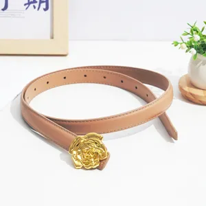 Close-up detail of the stylish women's leather belt featuring a luxury gold rose flower buckle.