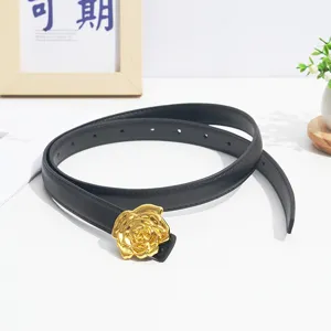 Detailed view of the black leather thin belt featuring an exquisite gold rose metal buckle.