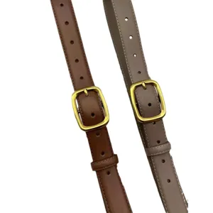 Minimalist women's leather belt with gold buckle, stylish brown and taupe waist accessory.