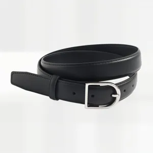 Close-up detail of a minimalist women's black leather belt with sleek silver buckle.