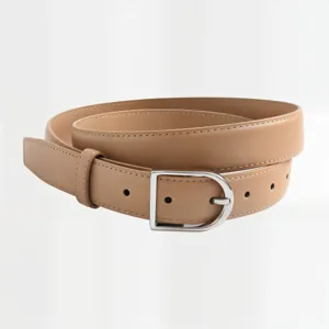Detail shot of a minimalist women's cowhide leather belt with silver D-buckle and white stitching.
