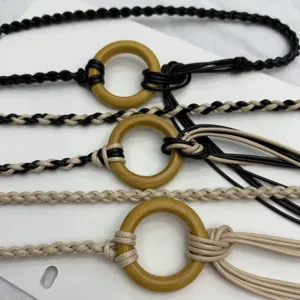 Bohemian vintage braided waist chain for women with wooden ring and tassel details.