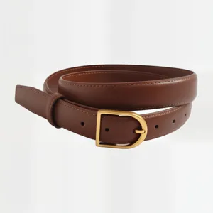 Close-up detail of premium brown leather belt with elegant gold buckle for women.