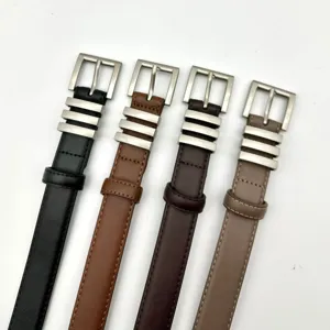Close up of stylish women leather belts in four colors with metal buckles and unique rings.