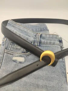 Women genuine leather belt with gold crescent moon buckle, stylish jeans waist accessory detail.