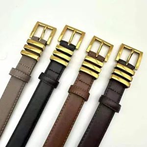 Close-up detail view of women's fashion leather belts featuring elegant gold metal hardware design.