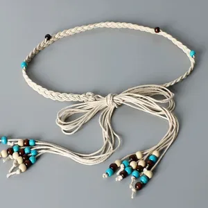 Detail view of bohemian braided rope belt, featuring natural wooden and turquoise beads.