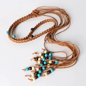 Detailed view of handmade braided wax rope waist chain with wooden and turquoise beads.