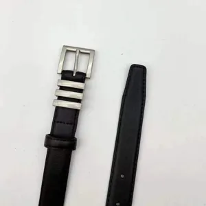 Detail view of women's black leather belt featuring silver-tone square buckle and metal loops.