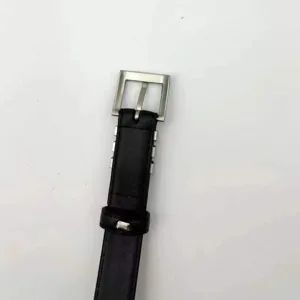 Black leather belt for women with silver metal buckle, stylish casual waist accessory for jeans.