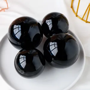 Black obsidian crystal sphere ornament for home decor, polished gemstone ball display.