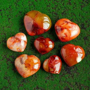 Natural red agate heart shaped palm stone crystal gemstone ornament for healing and decor.