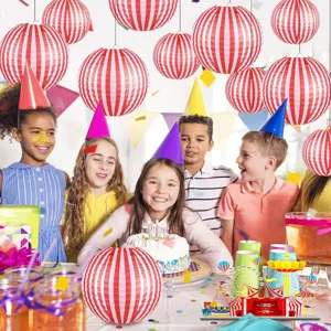 Red and white striped paper lanterns shown in a lively circus themed children birthday party setting.