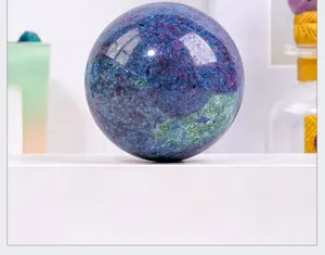 Natural crystal gemstone sphere ornament for home and office desktop decor close-up view.