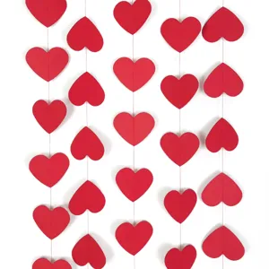 Red paper heart garland string for Valentine's Day party and wedding decoration details.