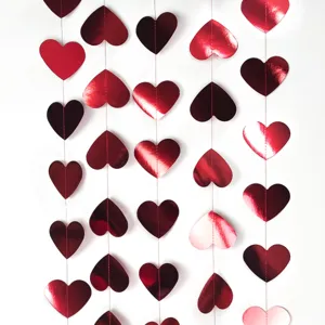 Detail shot of red metallic heart paper garland for Valentine day wedding party hanging decor.