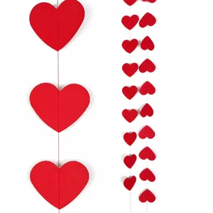 Valentine heart paper garland detail view, red hanging decorations for romantic party setup.